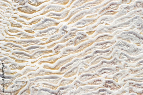 Textural background of asymmetric drawing. Natural texture of travertine Pamukkale. Close-up