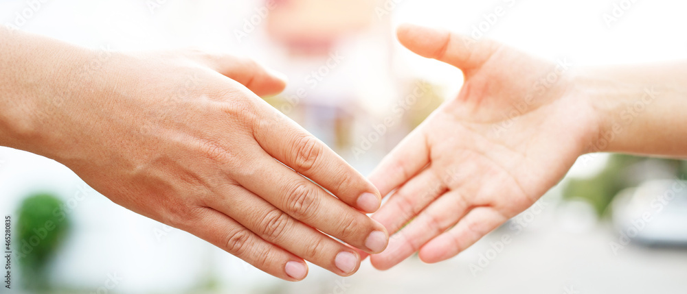 Closeup of a business hand shake between two colleagues Plaid shirt Closeup of a business hand shake between two colleagues Plaid shirt
