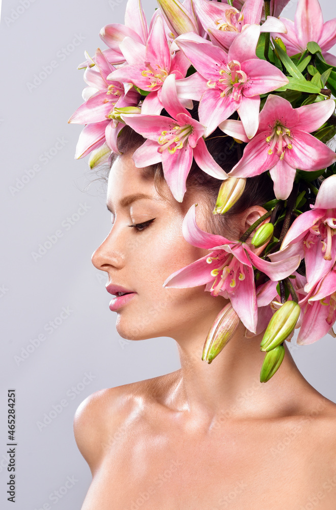 Beautiful woman with flowers in her hair. Bouquet of Beautiful Flowers. Hairstyle with flowers. Nature Hairstyle.