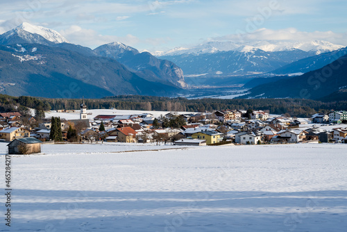 Snow covered alpine mountain village with view on Telfs, Wildermieming, Tirol, Austria photo