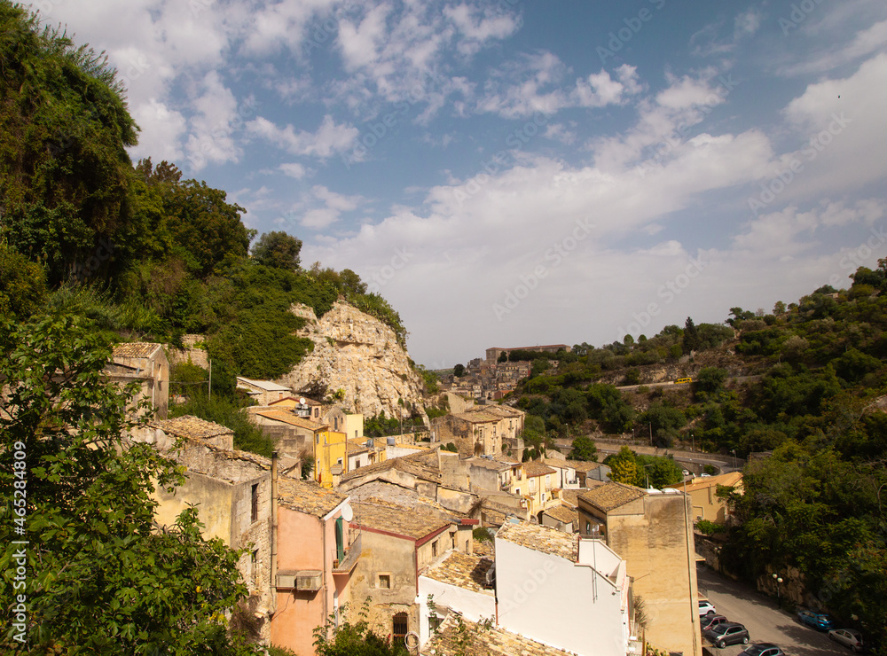 Top view panoramic city landscape of Sicilian Ragusa Ibla old town. Sandstone houses, curve roads and trees. Bright sunny view photo good for touristic booklets, travel company website, posters etc