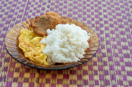 Rice with scrambled egg and fritters on a plate