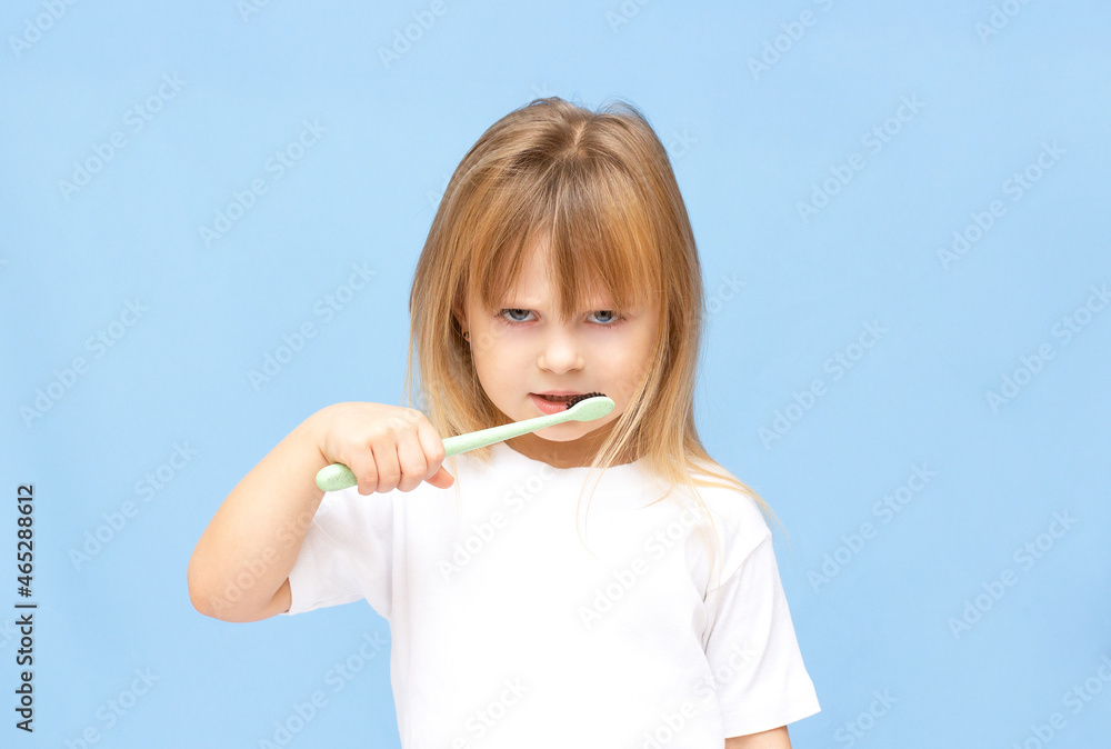 Little girl doesn't want to brush her teeth.Sad little girl with toothbrush Little girl doesn't want to brush her teeth.Sad little girl with toothbrush