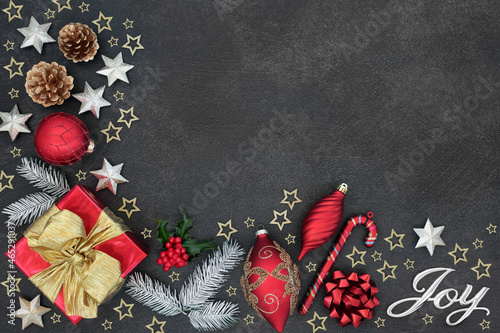 Fotografija Christmas joy abstract background border with silver sign, gift box, tree  decorations, winter greenery on grey grunge