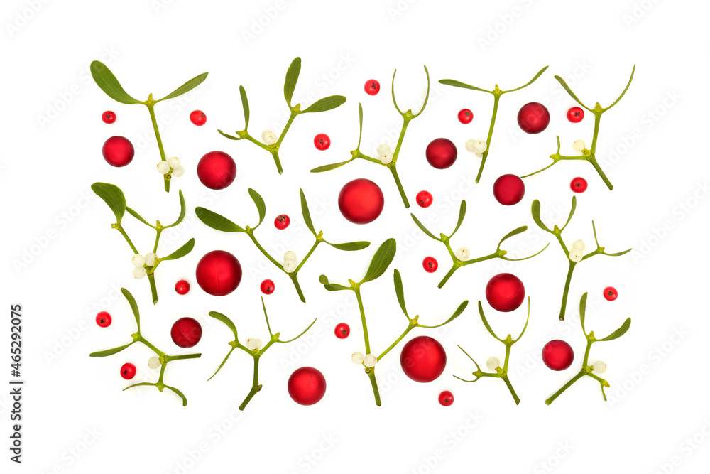 Christmas festive scene with red baubles, holly berries and mistletoe on white background. Abstract composition for the holiday season. Flat lay, top view. Christmas festive scene with red baubles, holly berries and mistletoe on white background. Abstract composition for the holiday season. Flat lay, top view.