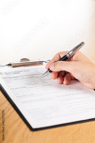 Person Filling a Medical Report Form