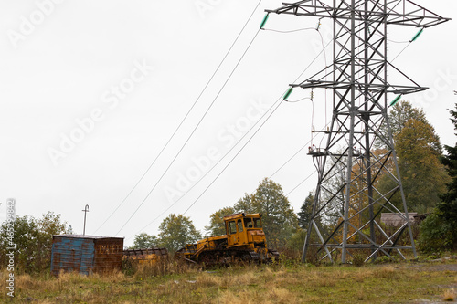 Russia. Adygea. Abandoned construction equipment near the power line. photo
