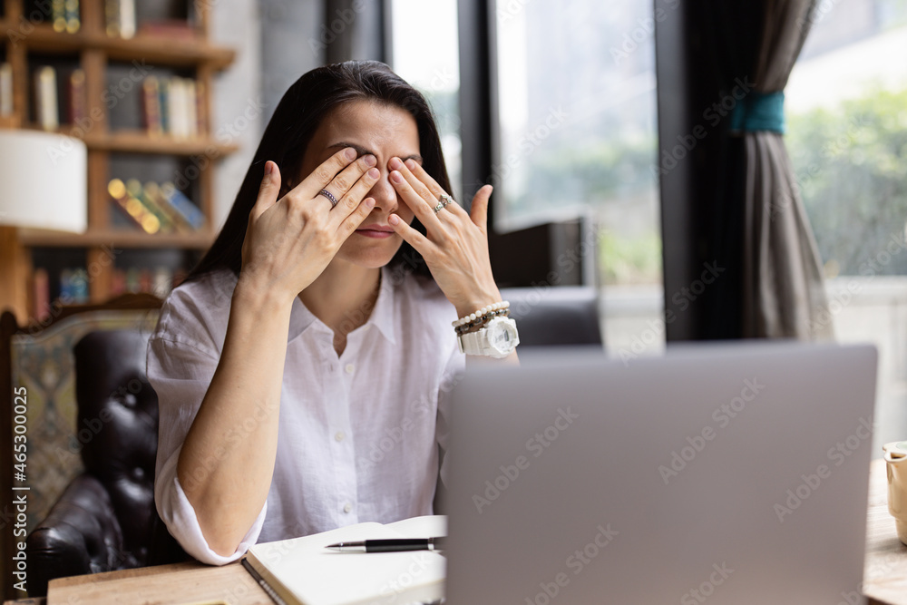 Young Caucasian business woman with long brunette hair working on laptop in cafe. College student using technology , online education, freelance Young Caucasian business woman with long brunette hair working on laptop in cafe. College student using technology , online education, freelance