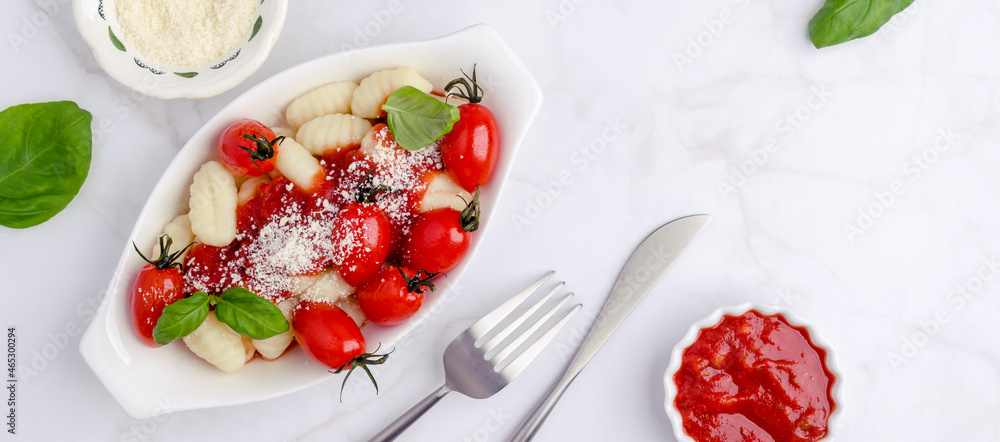 Gnocchi with tomatoes, red sauce, cheese and basil leaves Gnocchi with tomatoes, red sauce, cheese and basil leaves