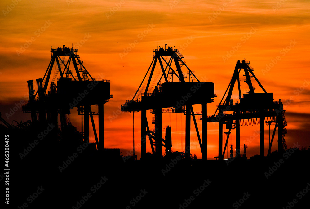 Silhouette photo during sunset, container lifting crane in Laem Chabang deep sea port, Thailand.