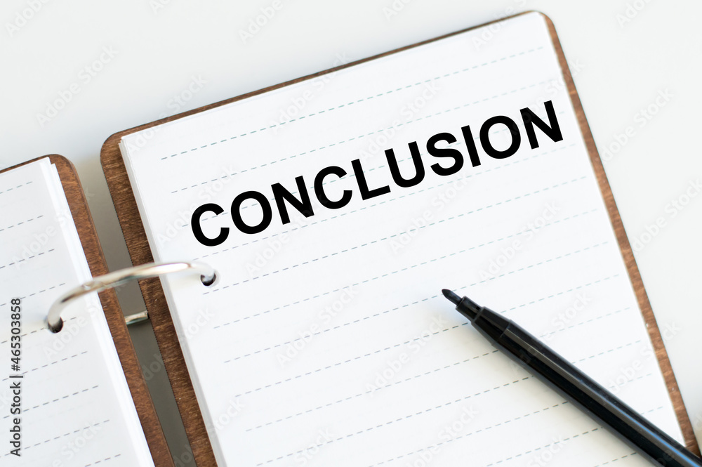 Conclusion text on a notebook with marker on a light background Conclusion text on a notebook with marker on a light background