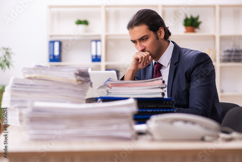 Young male employee unhappy with excessive work