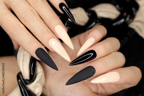 Beige and black manicure on long nails.