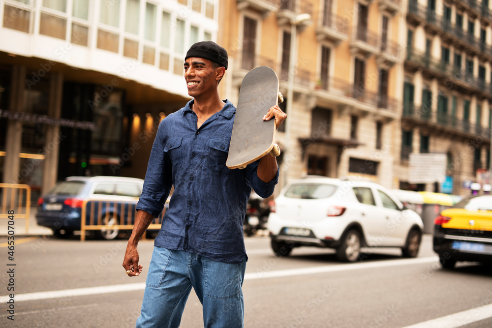 African man with skateboard. Young handsome man having fun outdoors. African man with skateboard. Young handsome man having fun outdoors.