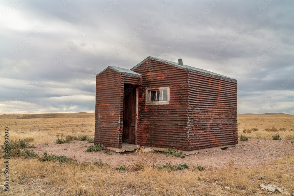 old, metal, rusty shack on a prairie - Soapstone Prairie Natural Area in northern Colorado old, metal, rusty shack on a prairie - Soapstone Prairie Natural Area in northern Colorado