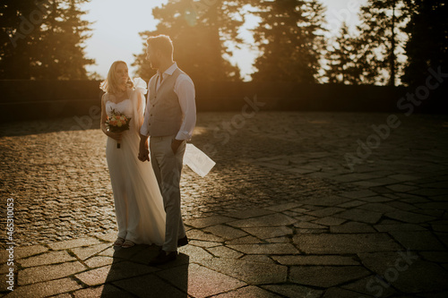 Young newlywed couple walki...