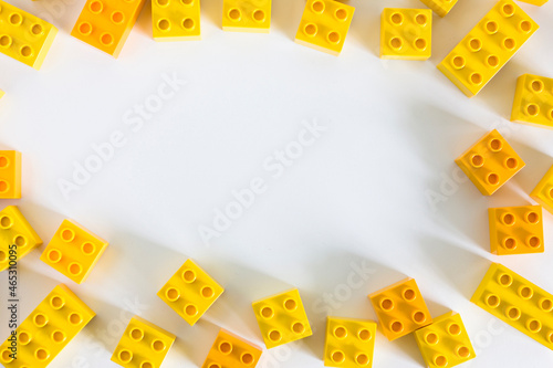 Yellow plastic building blocks with empty copyspace photo