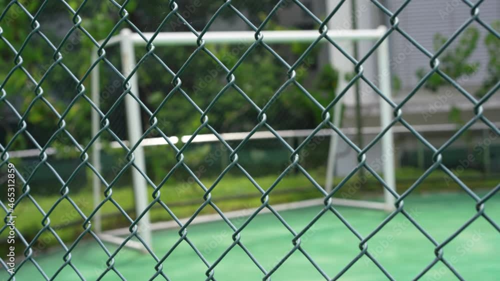 Soccer field behind fence. Football field behind chain link fence