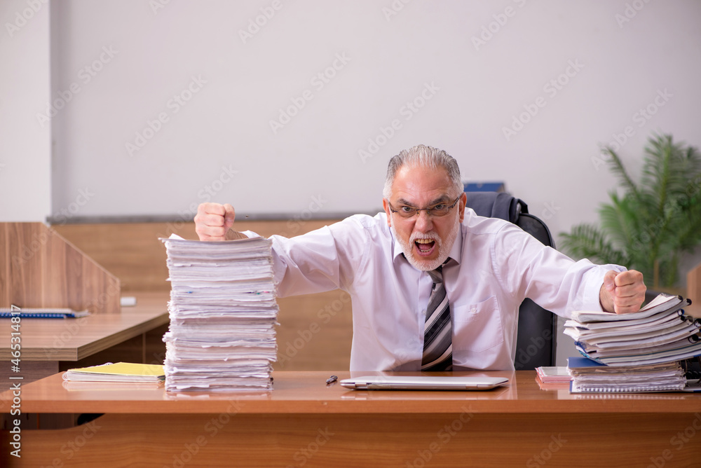 Old male employee and too much work in the office Old male employee and too much work in the office