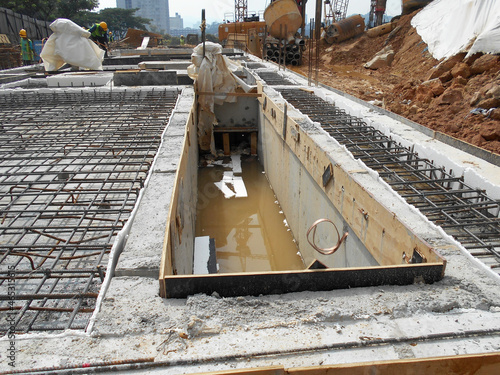 Photography KUALA LUMPUR, MALAYSIA -MARCH 29, 2021: Building ground beam under construction at the site using timber plywood as the formwork