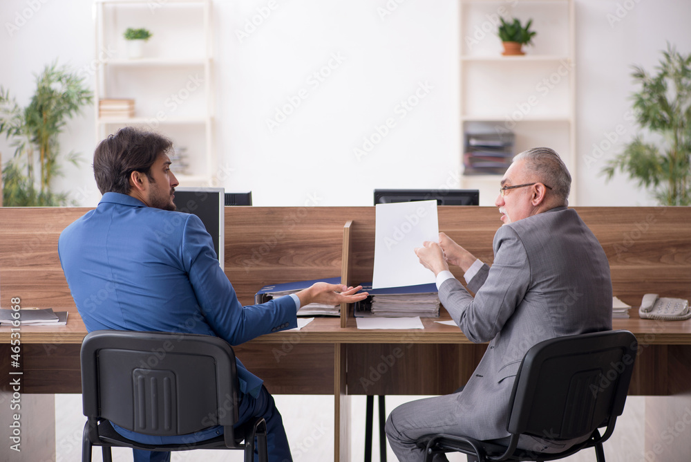 Two male employees working in the office Two male employees working in the office