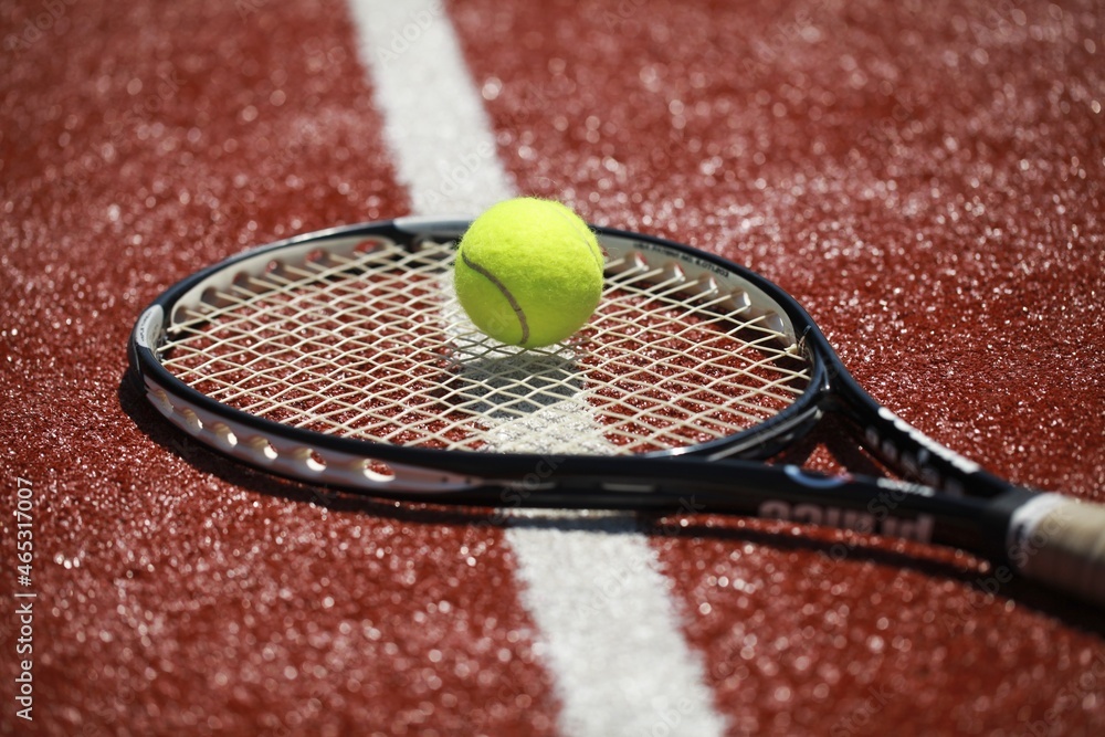 Tennis racket and tennis ball on sport court