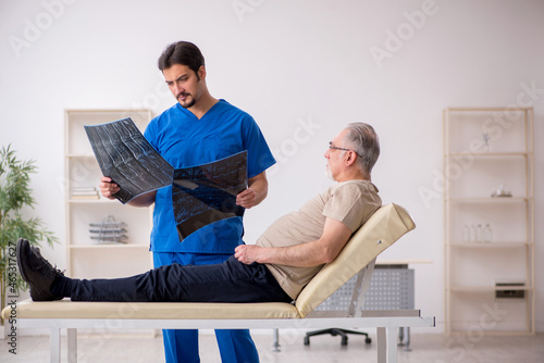 Old male patient visting young male doctor radilogist photo