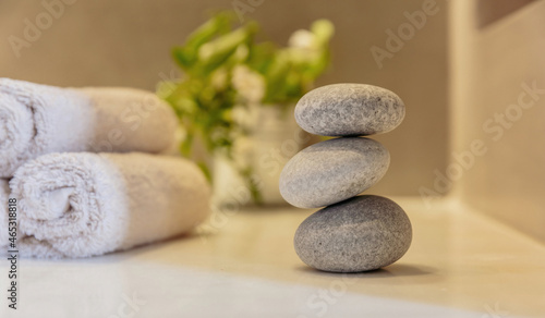 Zen stones, smooth pebbles pyramid stacked balance, wellness interior background.