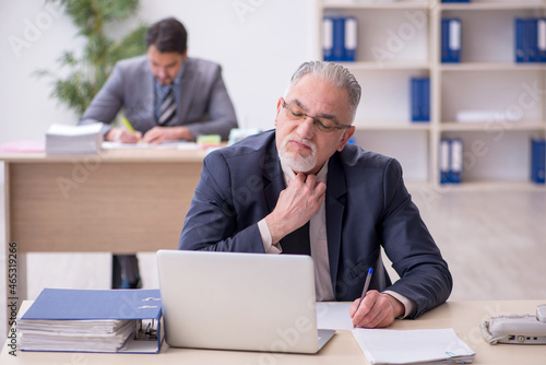 Two male employees working in the office