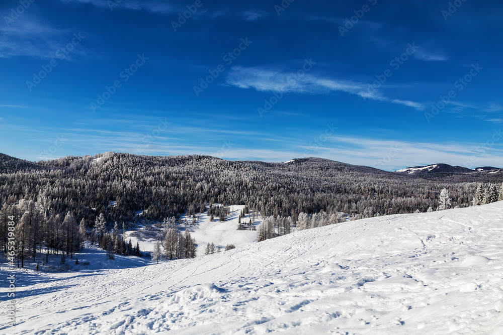 Beautiful winter landscape, mountains covered with snow, forest,  trees covered with frost on a sunny frosty day