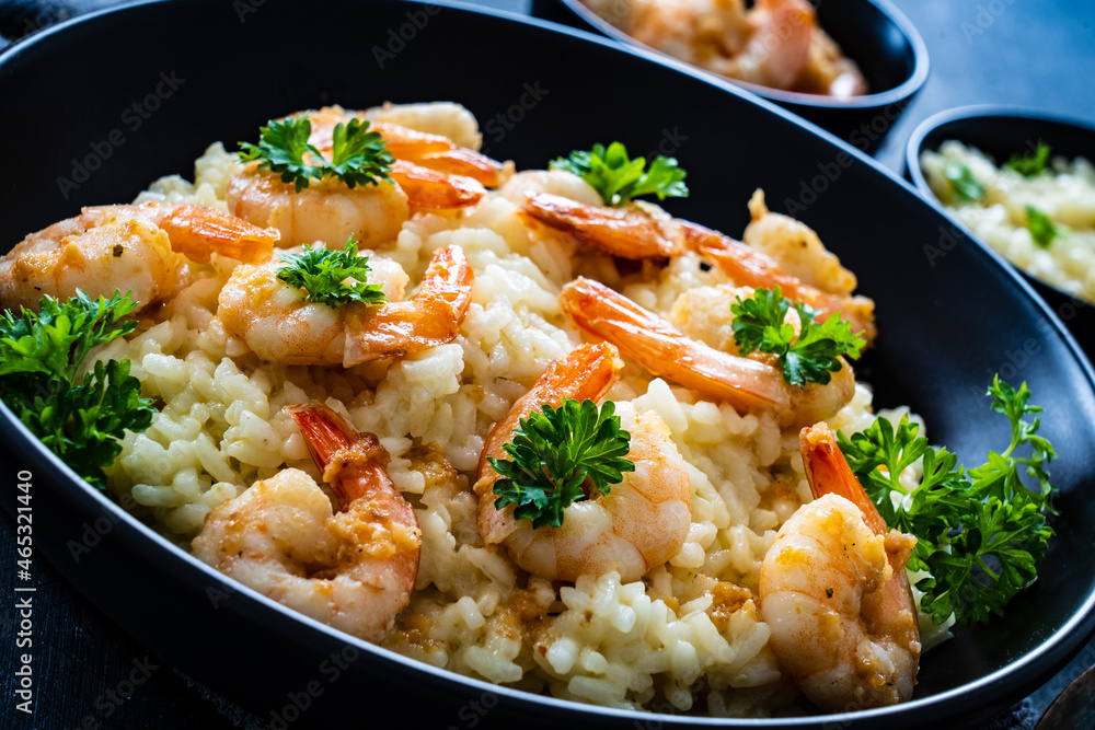 Risotto with prawns, chili and parsley on wooden table
Risotto with prawns, chili and parsley on wooden table