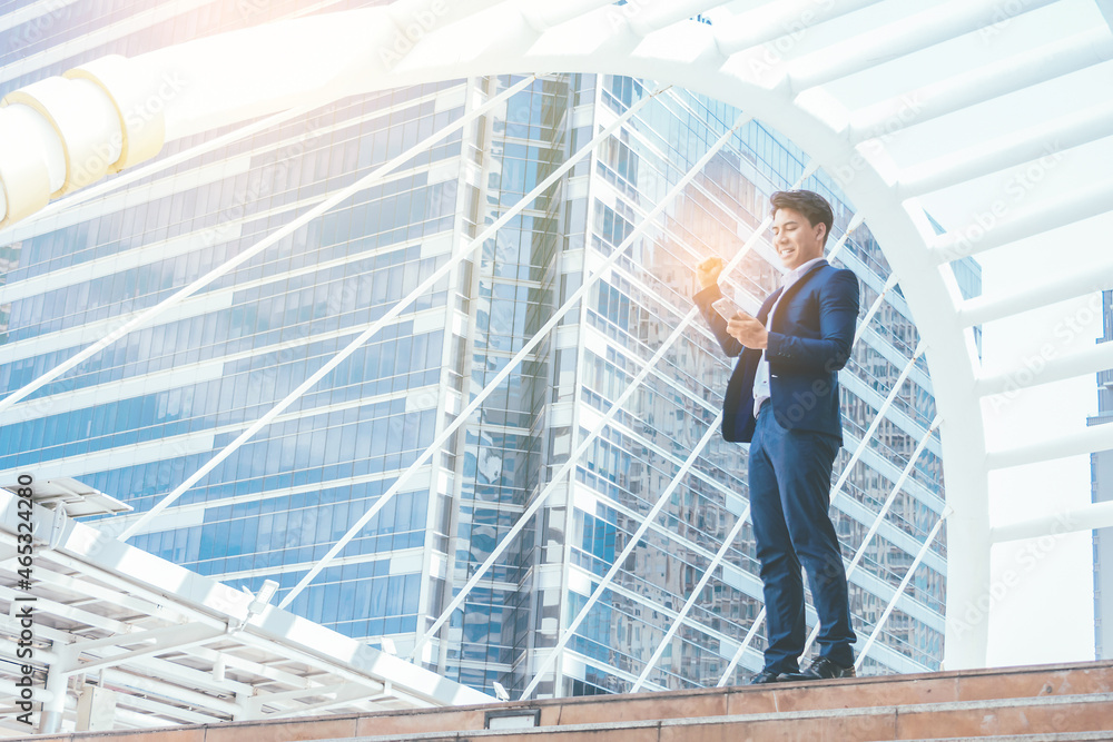 Young businessman in feeling happy because receive replies mail from business partners who agree to do business. Young businessman in feeling happy because receive replies mail from business partners who agree to do business.
