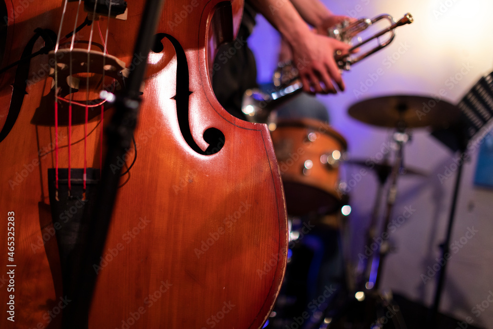 Fototapeta premium A good looking acoustic double bass captured from a live performance gig in a bar with a trumpet player in the background
