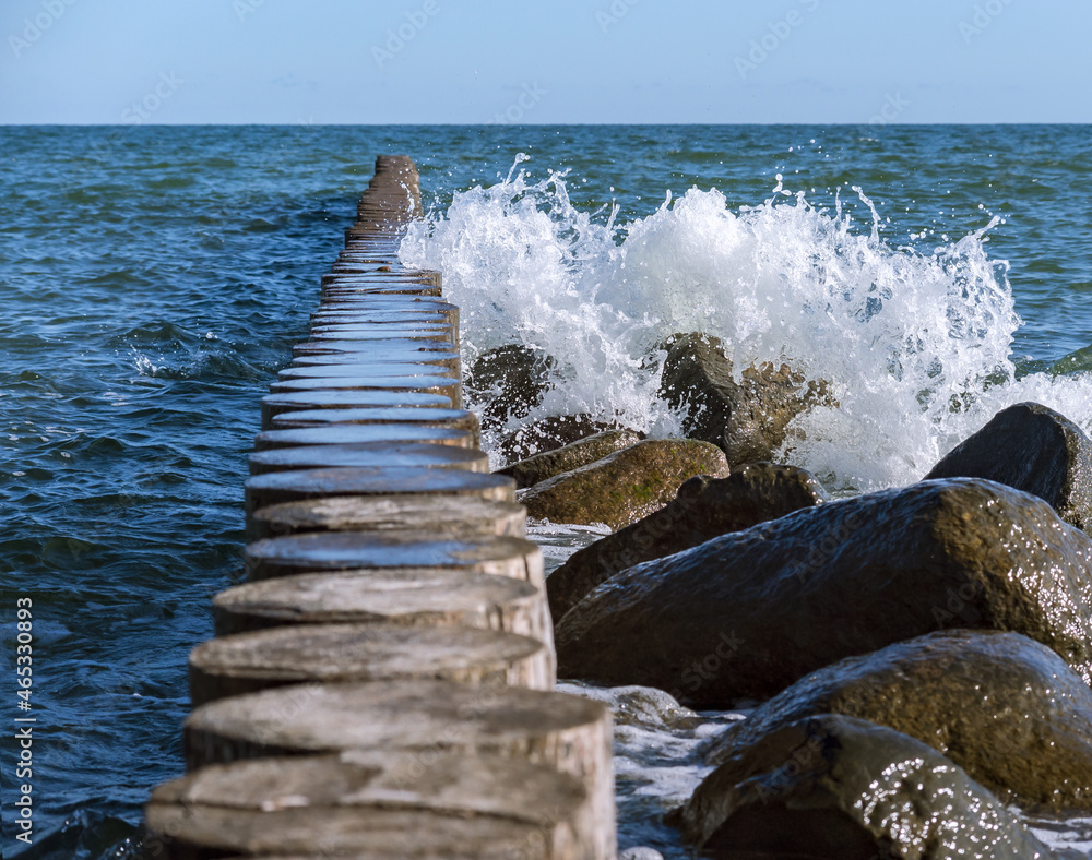Waves crashing on breakwaters. Sea wave splashing. Waves and a storm at sea. Baltic Sea. Waves crashing on breakwaters. Sea wave splashing. Waves and a storm at sea. Baltic Sea.
