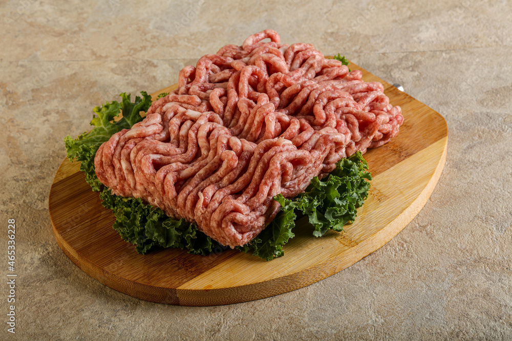 Raw pork minced meat over board Raw pork minced meat over board