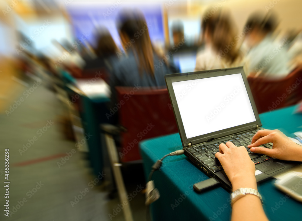 Business people typing on laptop keyboard at conference. Business people typing on laptop keyboard at conference.