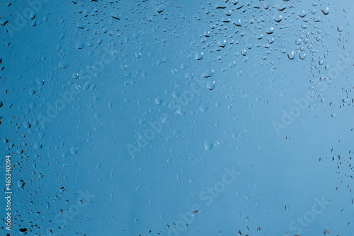 Blue backgrond with water drops. Wet glass. © Nikolay