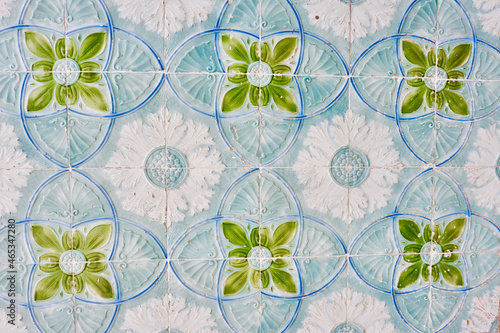 Authentic Portuguese tiles outside on the building wall in Portugal. Floral decorative ornament of blue, white and green colours