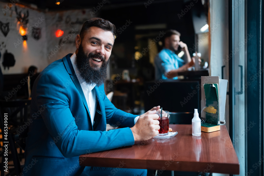 A businessman drinking his morning tea in a bar