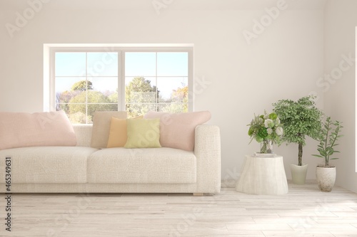 Stylish room in white color with sofa and autumn landscape in window. Scandinavian interior design. 3D illustration