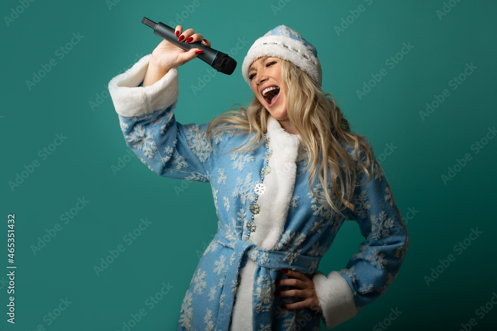 Singing beautiful female in New Year's outfit with a microphone Singing beautiful female in New Year's outfit with a microphone