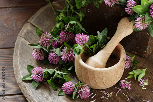 Red clover blossoms on wooden rustic background, herbal plant is used as immune, antioxidant, in cosmetics, closeup, naturopathy and natural medicine concept