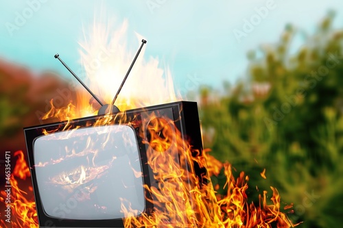 Fotografie Retro vintage TV is burning with fire