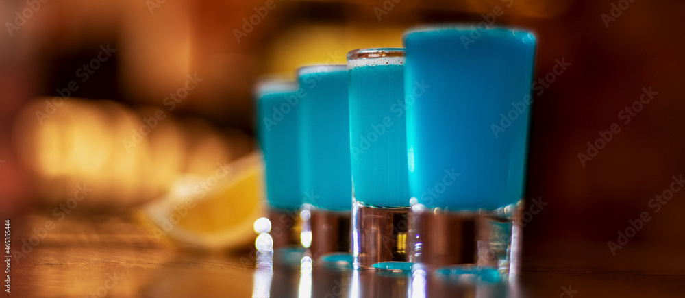 blue kamikaze shots on wooden table closeup panorama blue kamikaze shots on wooden table closeup panorama