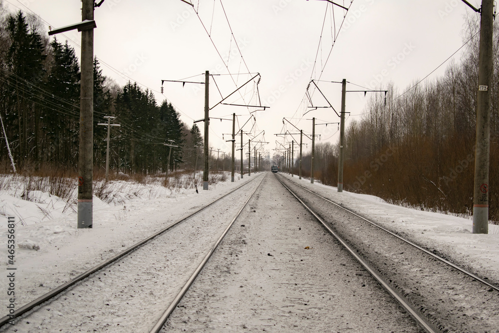 Railroad track stretching into the winter distance. Transport concept.