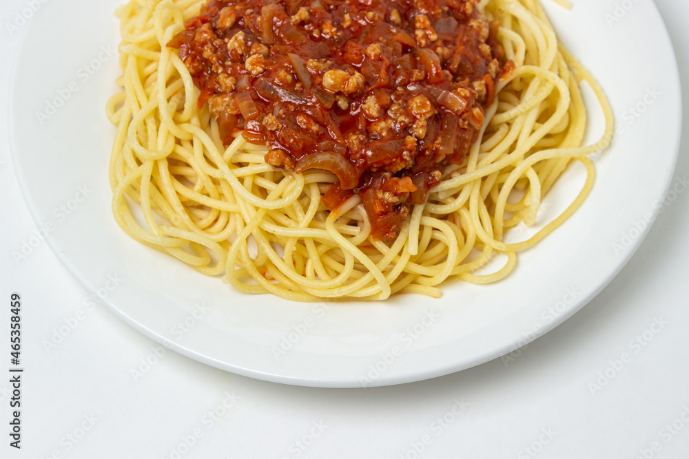 Spaghetti with meat gravy on a white plate. Traditional cooking Spaghetti with meat gravy on a white plate. Traditional cooking