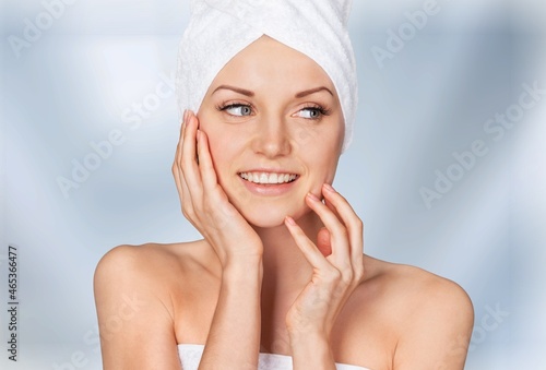 Happy beautiful young woman applying cream with collagen on dry skin