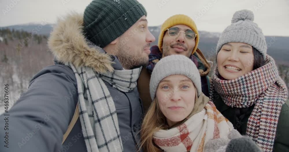 Portrait of joyful tourists male and female making online video call talking waving hand outdoors in mountains. Tourism and communication concept. Portrait of joyful tourists male and female making online video call talking waving hand outdoors in mountains. Tourism and communication concept.