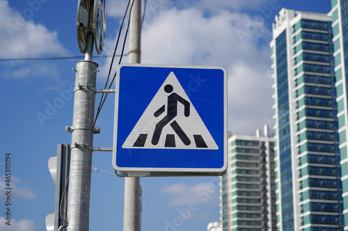 Photo of a square pedestrian crossing road sign on the street in the city