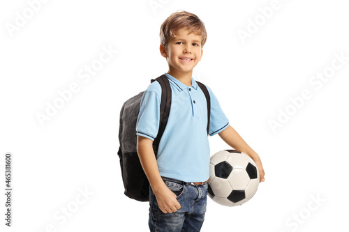 Cute schoolboy with a backpack holding a football © Ljupco Smokovski